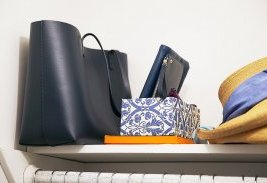 My bag in its proper resting place, alongside a little damask-covered box that holds a few clutches, making them visible and easy to grab when running out the door.